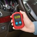 vehicle diagnostic scanning tool being used  inside car thumbnail