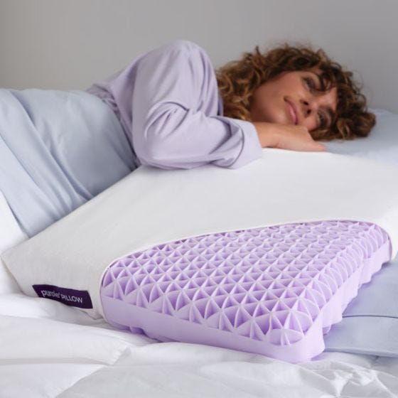 model laying with purple pillow model laying with purple pillow