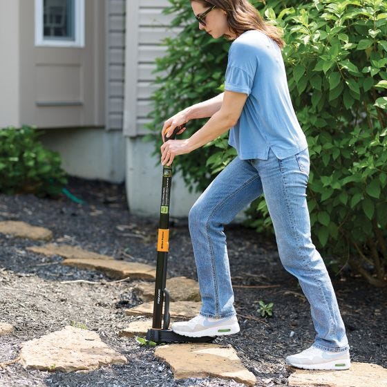 model removing weeds in between rocks 