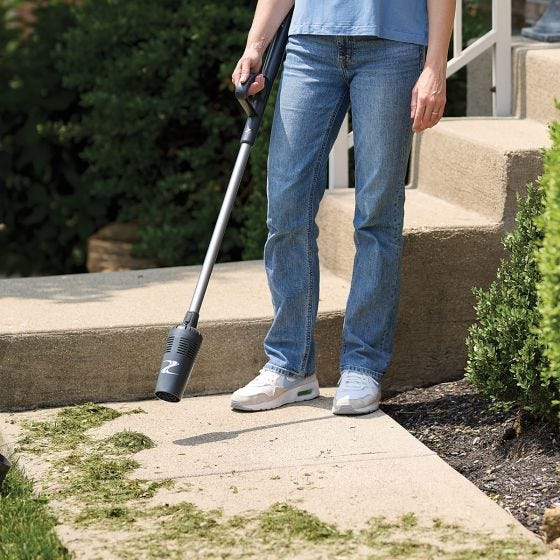 ZoomBroom blowing away grass on the sidewalk ZoomBroom blowing away grass on the sidewalk