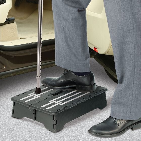 person using folding step to get into vehicle person using folding step to get into vehicle