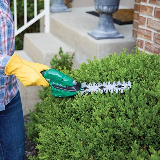 grass and hedge trimmer in use 