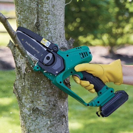 pruner saw cutting tree limbs 