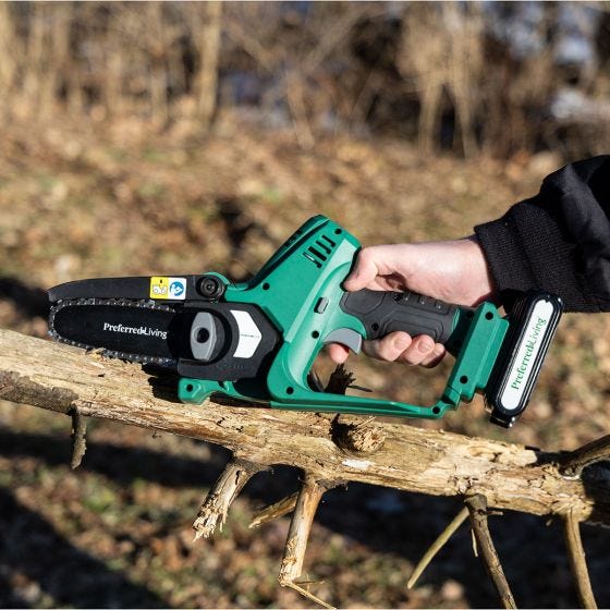 pruner saw cutting tree limbs 