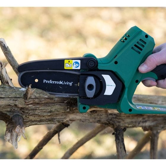 pruner saw cutting tree limbs 