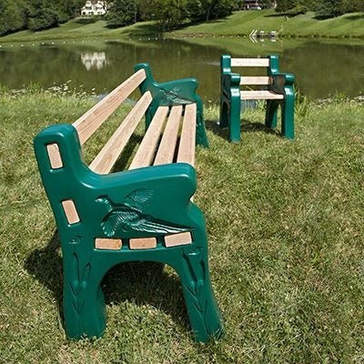 Side view of Park Bench on display by lake