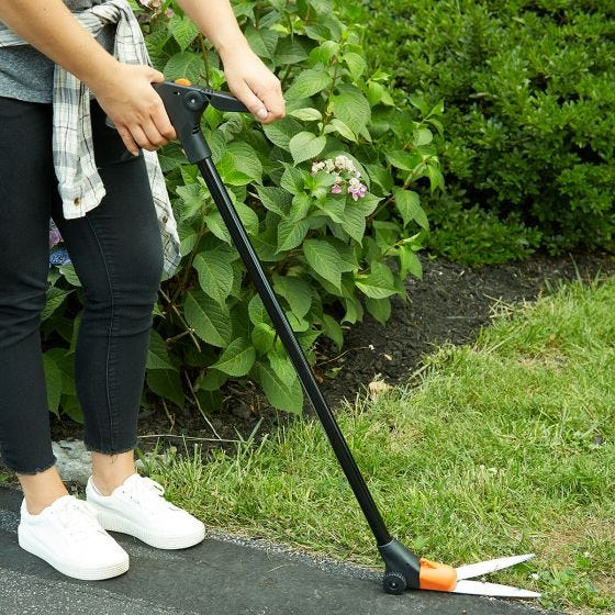 model using grass shears outside 