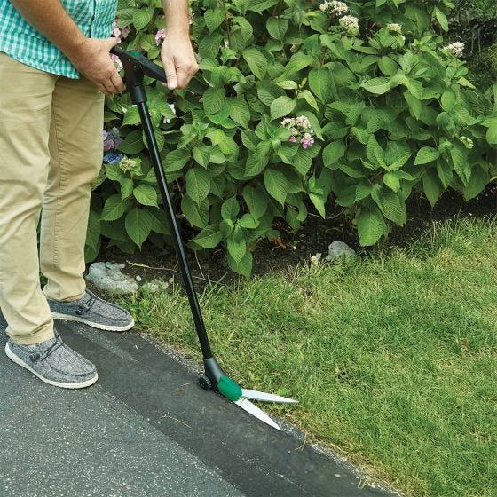 model using grass shears outside 