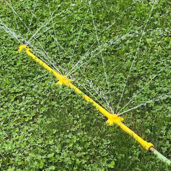 mower cleaner in grass spraying water