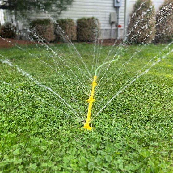 Mower cleaner spraying in grass