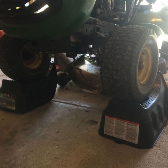 lawn mower on ramps in garage 