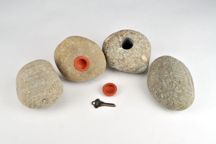 real rock key hiding stone on white