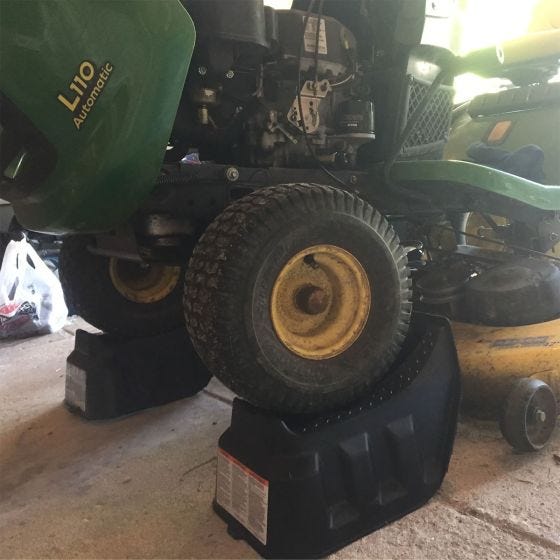 lawn mower on ramps in garage 