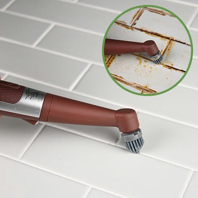 brown horsepower pocket pony power scrubber being used to clean tiles  