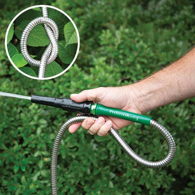 100' Stainless Steel Garden Hose being used to water lawn