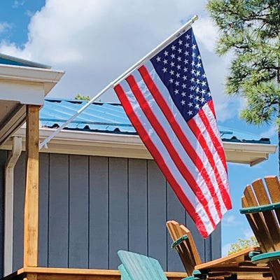 Tangle Free Flagpole with American Flag hanging on porch of nice home